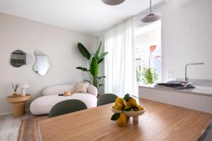 a living room with a dining room table and a bedroom at Vibra Tahiti Superior in Lido di Jesolo