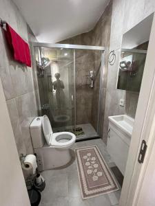 a man taking a picture of a bathroom with a shower at Villa 19 Apart Otel in Ilıca +44 photos