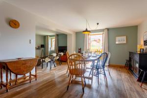 a kitchen and dining room with a table and chairs at Chalet Marijo: Sauna & Charme Alpin in Saint-Marcel