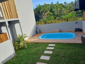 a swimming pool in the backyard of a house at Pousada Mon Gâté in Japaratinga