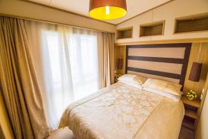 a bedroom with a bed and a large window at MP639 - Camber Sands Holiday Park - 3 Bedroom - Sleeps 8 - Large gated decking - Close to facilities in Camber