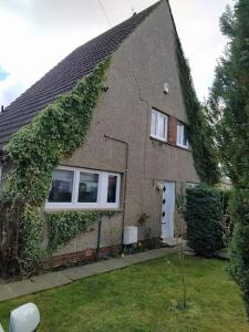 a house with ivy growing on the side of it at Studio Flat in Edinburgh