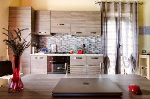 a kitchen with a table with a laptop on it at Agriturismo B&B La Cerasa in Fabriano