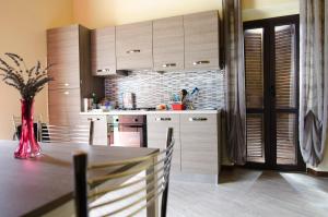 a kitchen with a table with a vase on it at Agriturismo B&B La Cerasa in Fabriano