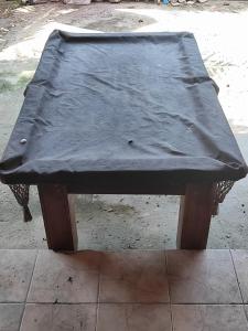 a wooden bench with a blanket on top of it at Casa de hóspedes Caraguatatuba in Caraguatatuba