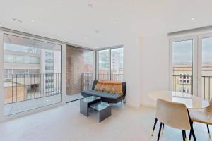 a living room with a couch and a table at 1Bed apt in Whitechapel with a balcony & near tube in London