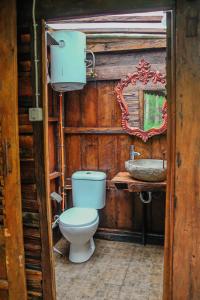a bathroom with a toilet and a sink at Omah kayu bromo in Ngadisari
