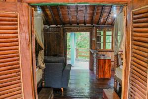 ein Zimmer mit einem Sofa und einem Stuhl in einem Haus in der Unterkunft Omah kayu bromo in Ngadisari