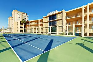 a tennis court in front of a building at Suntide II in South Padre Island