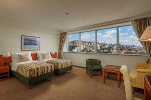 a hotel room with a bed and a large window at Grand Hotel Bonavia in Rijeka +50 photos