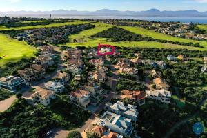 an aerial view of a suburb with a red arrow at Living on a Golf Estate in Mossel Bay