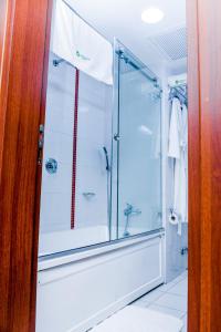 a shower with a glass door in a bathroom at LIMEWOOD HOTEL in Port Harcourt