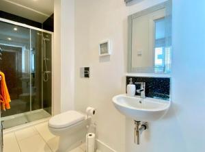 a bathroom with a sink and a toilet and a shower at Lowen Chy 1 Green Hill in Wadebridge