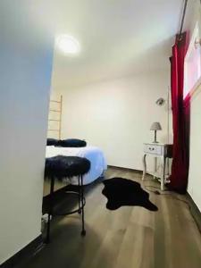 a bedroom with a bed and a desk and a chair at JACUZZI Aixclusive in Le Tholonet