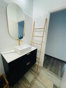 a bathroom with a sink and a mirror and a ladder at JACUZZI Aixclusive in Le Tholonet
