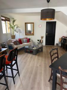 a living room with a couch and a table at Chez Mag in Lille