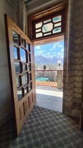 an open door with a view of a balcony at Baltistan Continental in Skardu