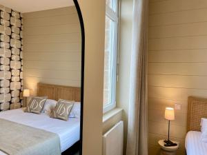 Cama ou camas em um quarto em Hôtel Les Costans, The Originals Relais