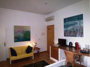 a living room with a yellow chair and a desk at Ferienwohnung für 2 Personen ca 25 m in Sencelles, Balearen Mallorca in Sencelles