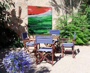 a table with four chairs and a painting on the wall at Ferienwohnung für 2 Personen ca 25 m in Sencelles, Balearen Mallorca in Sencelles +14 photos