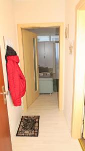 a room with a red bag hanging on the door at Schönes Appartement in Burhave in Butjadingen +3 photos