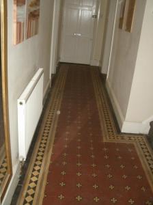 a hallway with a tile floor and a white door at Contractors House Edgbaston in Birmingham
