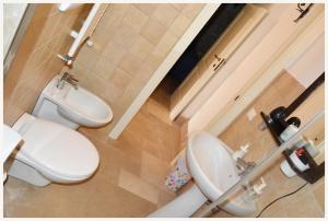 a bathroom with a white toilet and a sink at Trulli Beauty LAMIA family pool in Martina Franca +7 photos