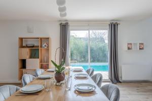 a dining room with a long table and chairs at Blue Villa near Disneyland Paris in Chalifert