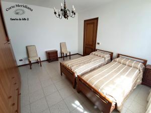 Postel nebo postele na pokoji v ubytování Corte Meridiana