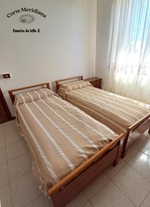 Postel nebo postele na pokoji v ubytování Corte Meridiana
