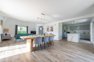 a kitchen and living room with a table and chairs at Blue Villa near Disneyland Paris in Chalifert