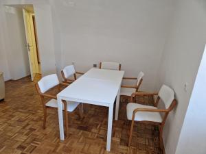 a white table and chairs in a room at Dom Nazaret in Nazarje