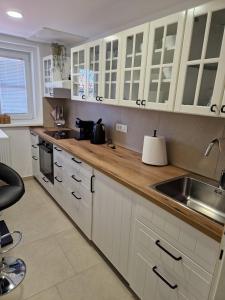 a kitchen with white cabinets and a sink at Dom Nazaret in Nazarje