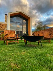 a fire pit and two benches in front of a house at Mono house kartepe in Kocaeli