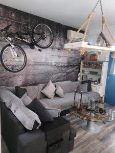 a living room with a couch and a bike on the wall at George's point of view in Naousa