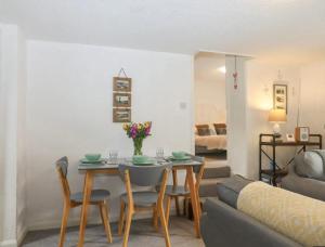 a living room with a table and a couch at Stokeinteignhead, South Devon, Character Countryside Apartment in Stokeinteignhead