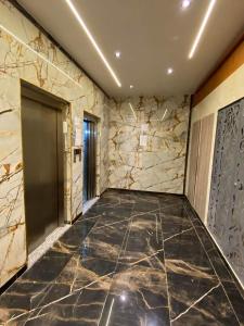 Delmonte的住宿－APPARTEMENT AMINE，走廊上设有大理石地板和门