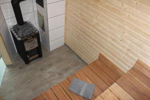 a room with a brick wall and a wood stove at Ferienhaus "Waldidyll Brunni" in Marlow +13 photos