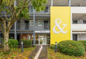 a building with a sign on the side of it at B&B HOTEL CALAIS Coquelles Tunnel sous La Manche in Coquelles