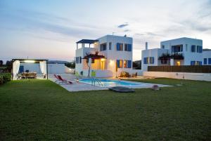 a house with a swimming pool in the yard at White Houses Villas in Gennadi