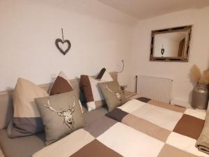 a bedroom with a bed with pillows and a mirror at Landhaus Schusterfranz in Passail