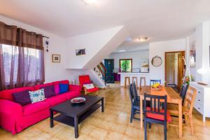 a living room with a red couch and a table at Wohnung in Playa De La Calera mit Privatem Parkplatz in Valle Gran Rey