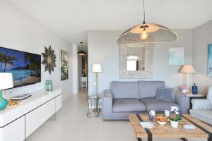 a living room with a blue couch and a table at El Balcon de Salinetas MF by VillaGranCanaria in Telde