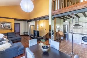 two views of a living room and dining room at Caserío Zubieta in Orózqueta