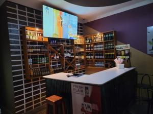 a bar in a store with a large screen at Galaxy Executive INN,Bar & Restaurant Wakiso in Wakiso