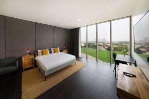 a hotel room with a bed and a desk at Emirates Sports Hotel Apartments, Dubai Sports City in Dubai