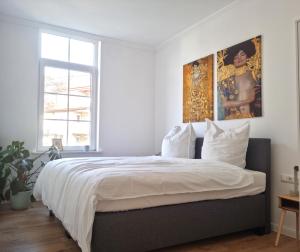 a bedroom with a large bed with a painting on the wall at Villa Högemann in Wilhelmshaven
