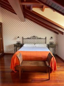 a bedroom with a bed and two night stands at Casa de Costoia in Santiago de Compostela