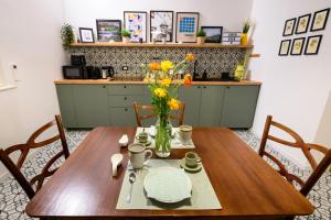 a wooden table with a vase of flowers on it at ARYA Bed and Breakfast in Roccasecca