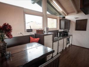 a kitchen with a table and a counter top at Holiday home with whirlpool and sauna in Viechtach in Viechtach
